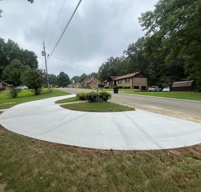 Freshly poured curved residential concrete driveway