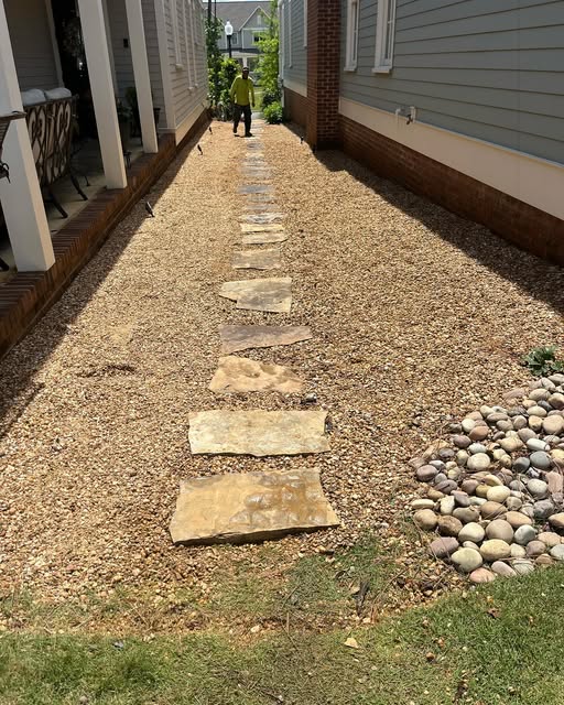 Gravel walkway with natural stepping stones and river rock detail