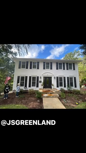 Fresh landscaping around the front of a two-story home